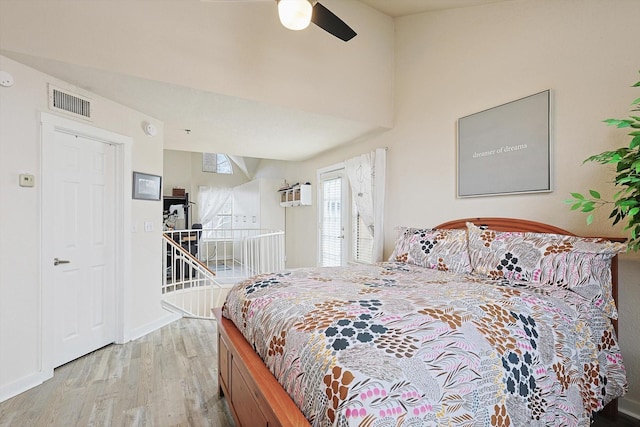 bedroom featuring visible vents, baseboards, wood finished floors, and a ceiling fan