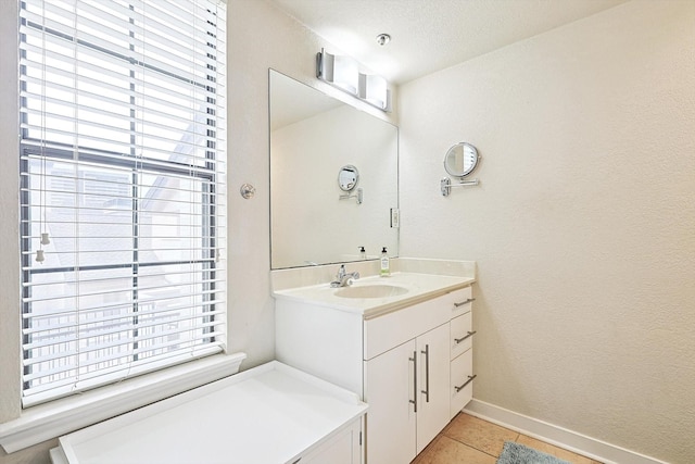 bathroom featuring baseboards, vanity, and tile patterned flooring