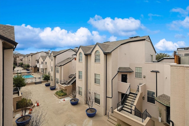 view of property exterior with a residential view and stucco siding