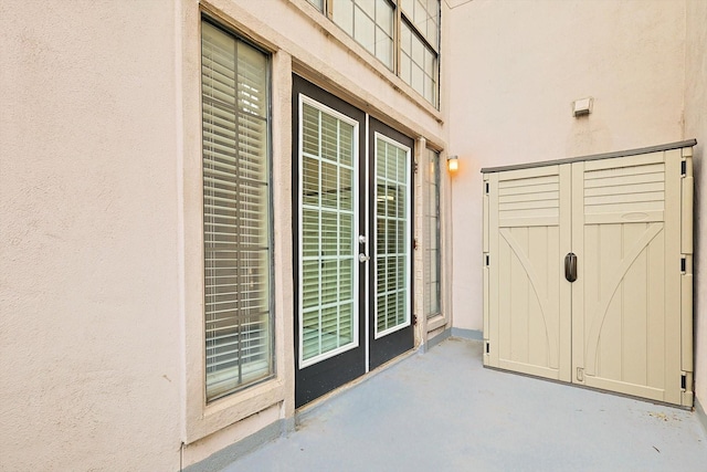 entrance to property featuring stucco siding