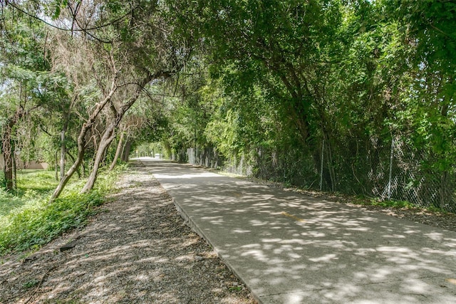 view of street featuring a forest view