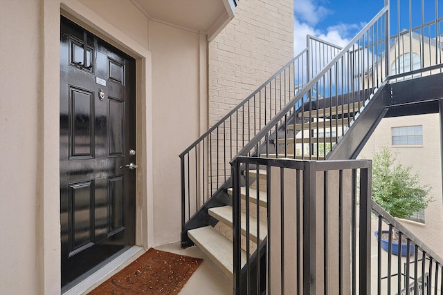 view of exterior entry featuring brick siding