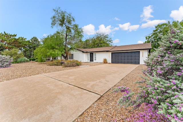 single story home featuring a garage and concrete driveway