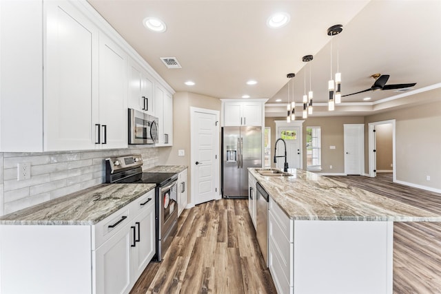 kitchen with visible vents, appliances with stainless steel finishes, a sink, and recessed lighting