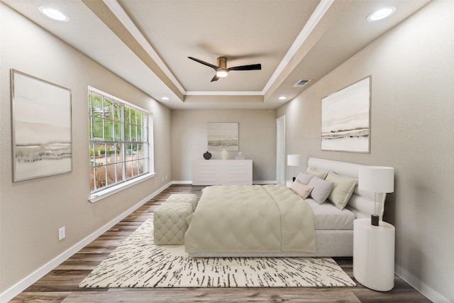 bedroom featuring dark wood-style floors, recessed lighting, a raised ceiling, visible vents, and baseboards