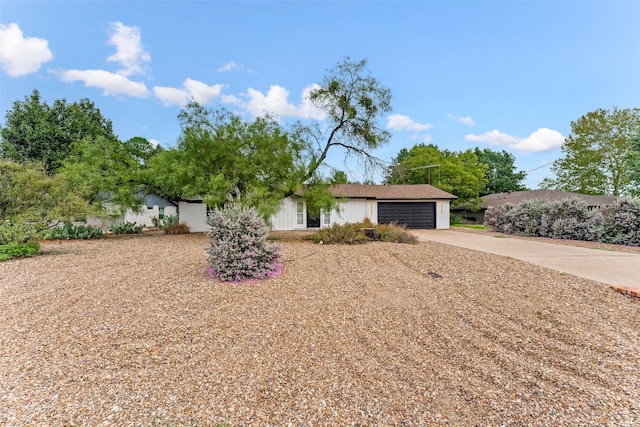 ranch-style home with a garage and concrete driveway