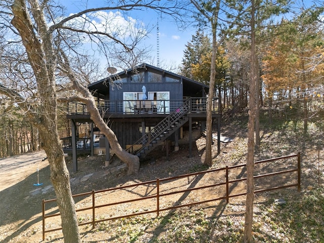 back of property featuring stairs, fence, and a wooden deck