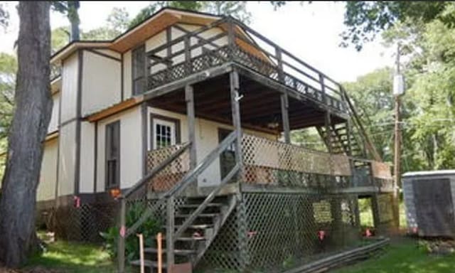 rear view of property with stairs