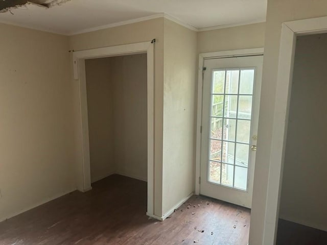 doorway to outside featuring crown molding and wood finished floors