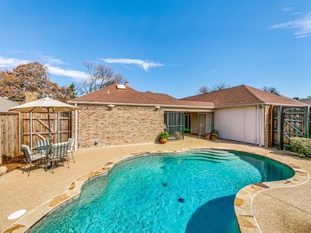 view of pool with a fenced in pool, a patio, and fence