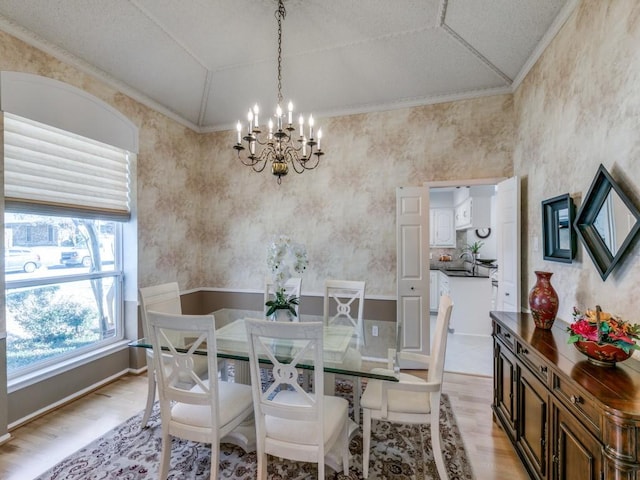 dining area featuring vaulted ceiling, a notable chandelier, and light wood finished floors