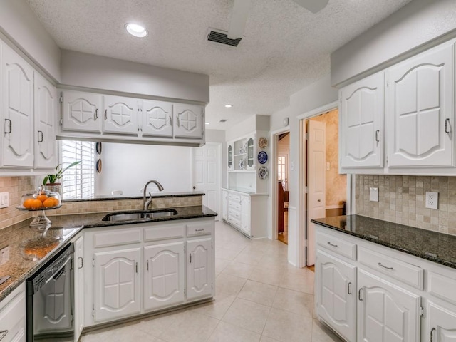 kitchen with white cabinets, visible vents, a sink, and dishwasher