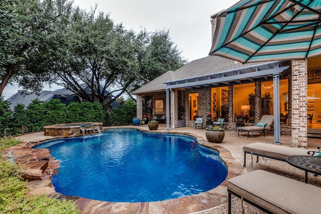 view of swimming pool with a patio and a pool with connected hot tub