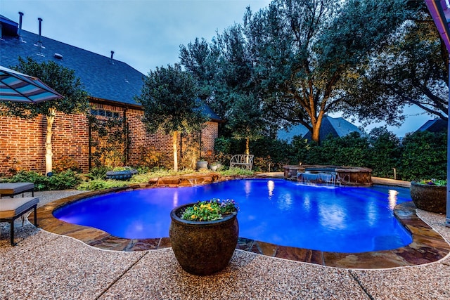 view of swimming pool featuring a patio and a pool with connected hot tub