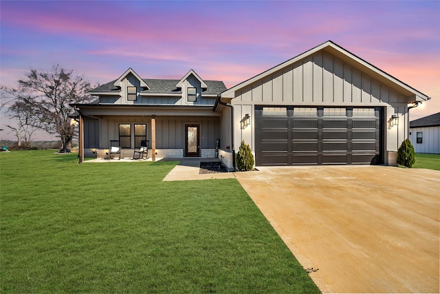 modern farmhouse style home with roof with shingles, a yard, board and batten siding, a garage, and driveway