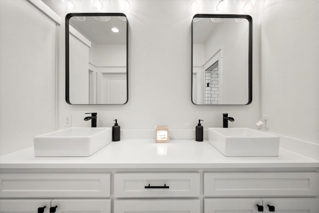 full bathroom with a sink and double vanity