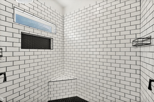 full bathroom with tiled shower