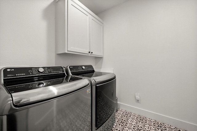 washroom featuring independent washer and dryer, tile patterned flooring, cabinet space, and baseboards