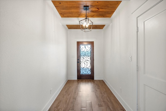 doorway to outside with wood ceiling, baseboards, wood finished floors, and beamed ceiling