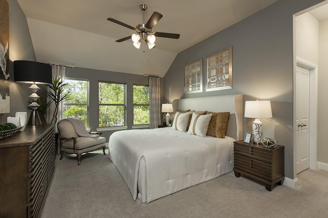 carpeted bedroom featuring lofted ceiling, ceiling fan, and baseboards