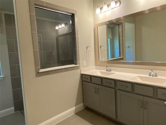 bathroom with a walk in shower, a sink, baseboards, and double vanity