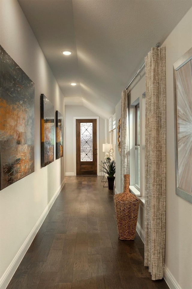 hall featuring dark wood-style floors, vaulted ceiling, recessed lighting, and baseboards