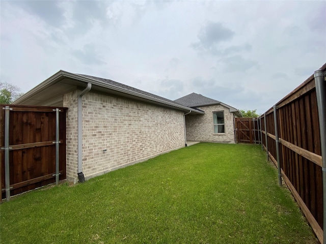 view of yard featuring a fenced backyard and a gate