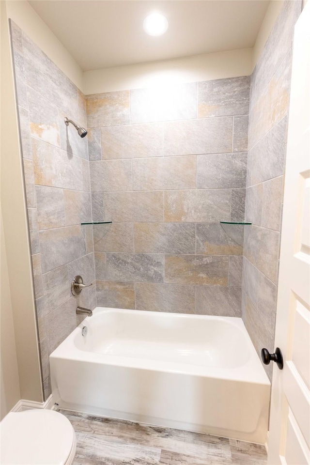 bathroom featuring shower / bath combination, toilet, and wood finished floors