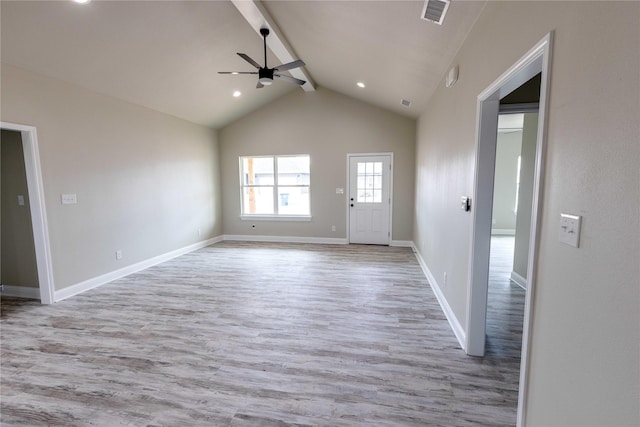 interior space with visible vents, lofted ceiling with beams, ceiling fan, wood finished floors, and baseboards