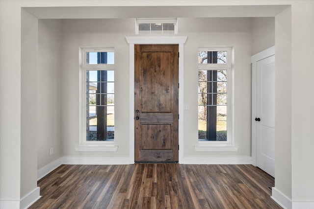 entrance foyer with dark wood-style flooring, visible vents, and baseboards