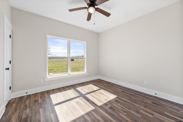 empty room with a ceiling fan, baseboards, and wood finished floors