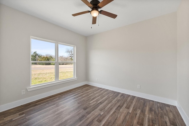 unfurnished room featuring ceiling fan, baseboards, and dark wood-type flooring