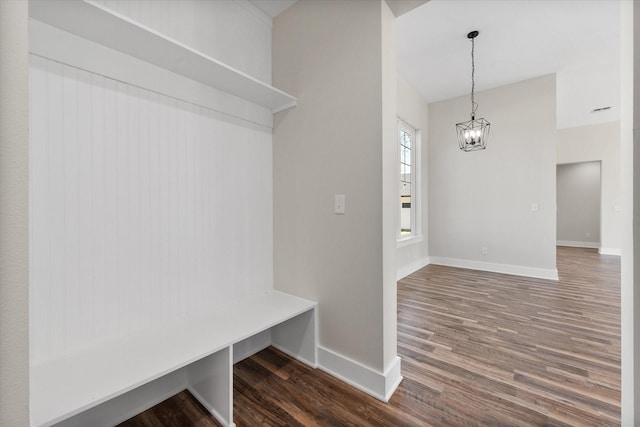 mudroom featuring an inviting chandelier, baseboards, and wood finished floors