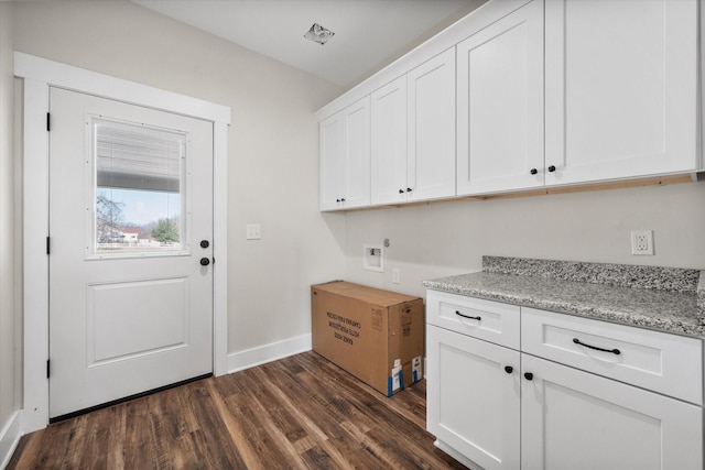 laundry area with hookup for a washing machine, dark wood-style flooring, cabinet space, and baseboards