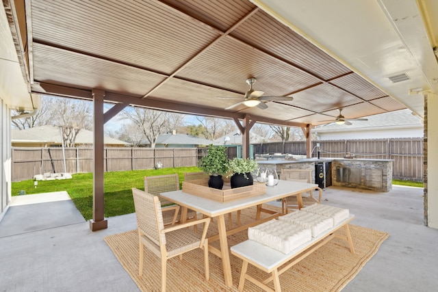 view of patio / terrace featuring visible vents, a ceiling fan, area for grilling, a fenced backyard, and outdoor dining space