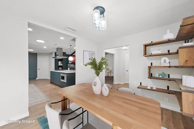 dining space with recessed lighting, baseboards, visible vents, and light wood finished floors