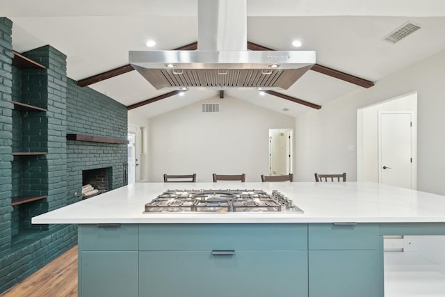 kitchen featuring island range hood, visible vents, lofted ceiling with beams, stainless steel gas stovetop, and open shelves