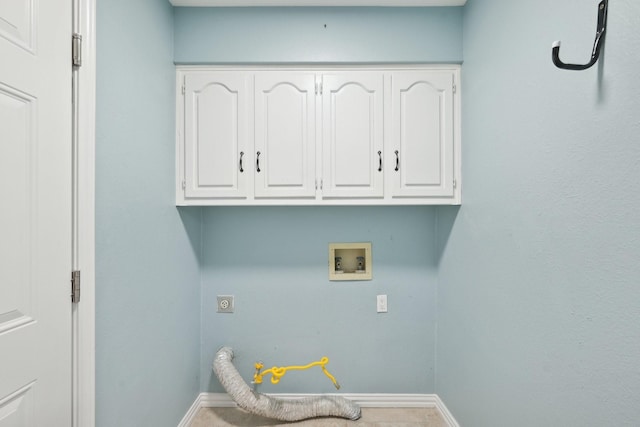 clothes washing area with hookup for a washing machine, hookup for a gas dryer, cabinet space, electric dryer hookup, and baseboards