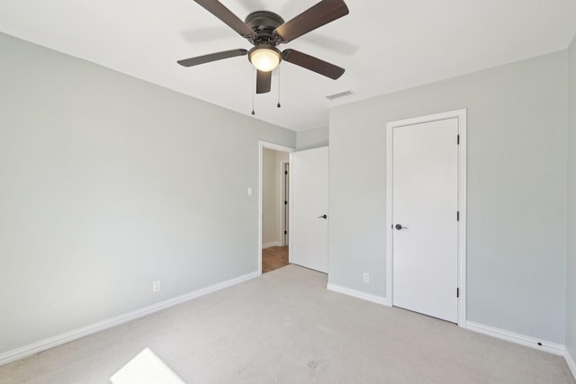 unfurnished bedroom with visible vents, ceiling fan, light carpet, and baseboards