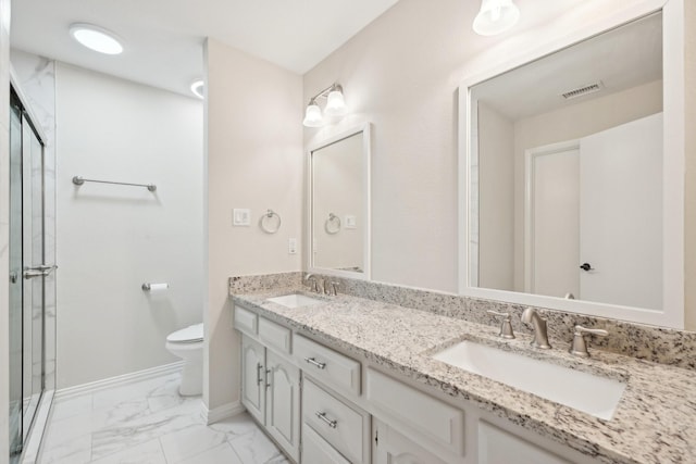 bathroom featuring toilet, marble finish floor, visible vents, and a sink