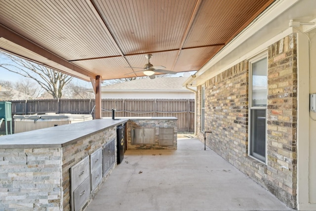 view of patio with a fenced backyard, ceiling fan, and area for grilling