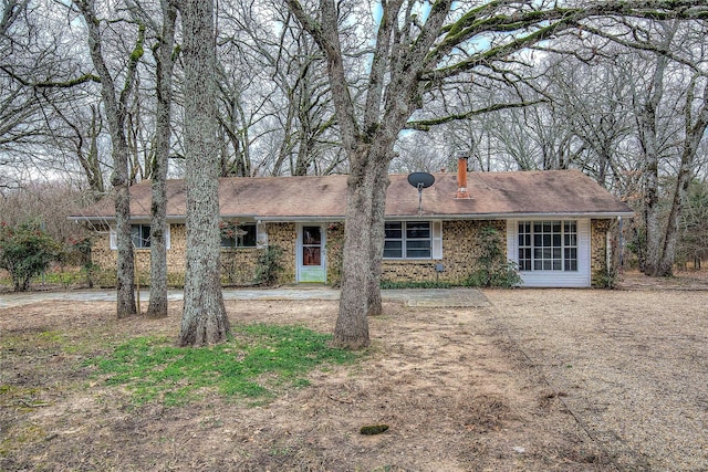 ranch-style house featuring brick siding