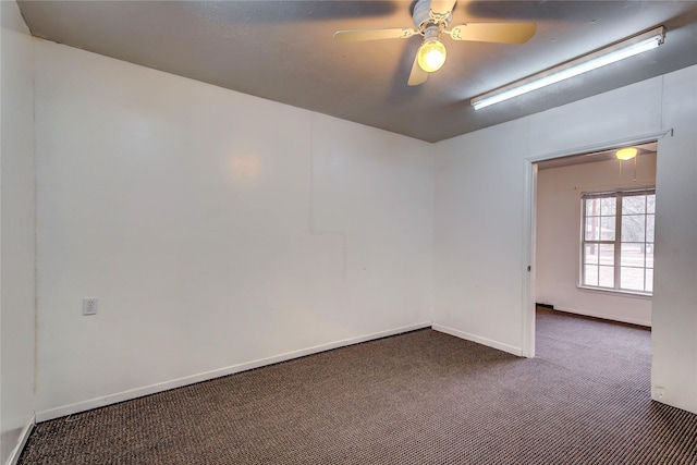 unfurnished room featuring carpet flooring, a ceiling fan, and baseboards