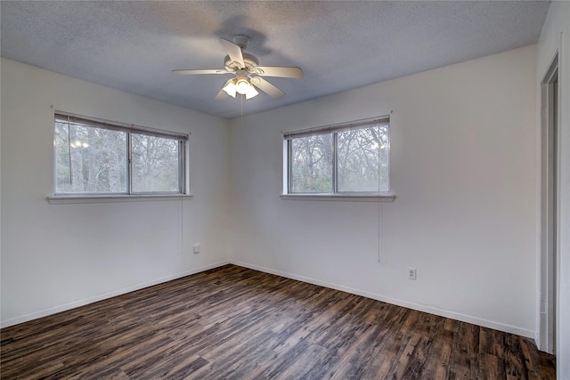 unfurnished room with ceiling fan, a textured ceiling, baseboards, and wood finished floors