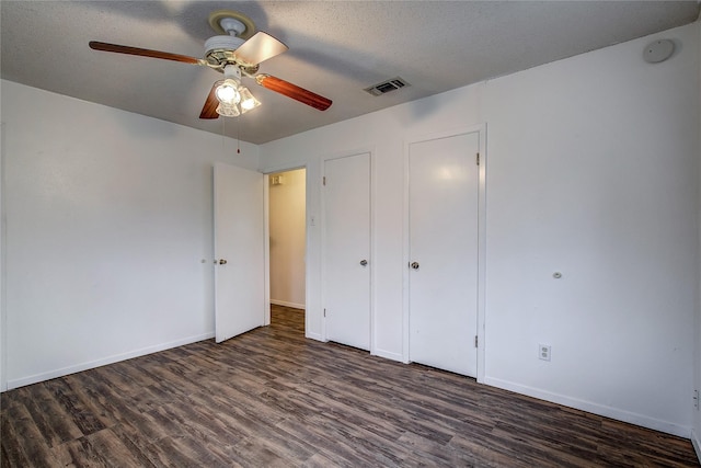 unfurnished bedroom with visible vents, ceiling fan, a textured ceiling, wood finished floors, and baseboards