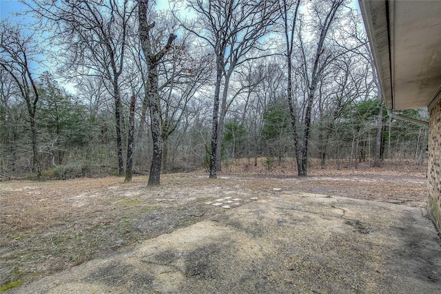 view of yard featuring a forest view