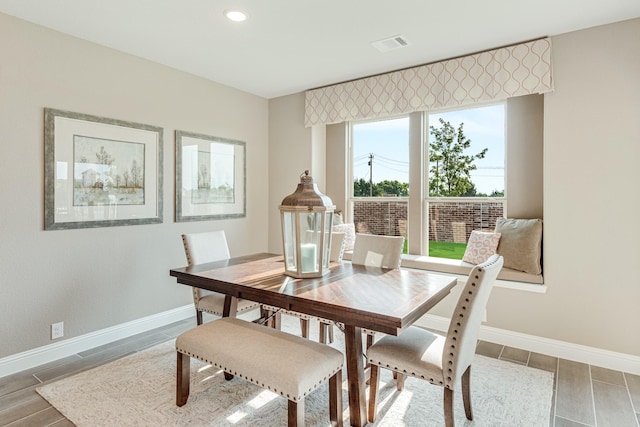 dining space with recessed lighting, visible vents, baseboards, and wood finish floors