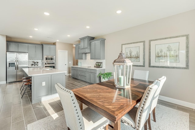 dining room with baseboards and recessed lighting