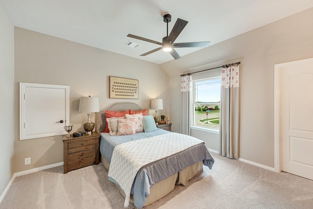 bedroom featuring baseboards, visible vents, vaulted ceiling, and light colored carpet