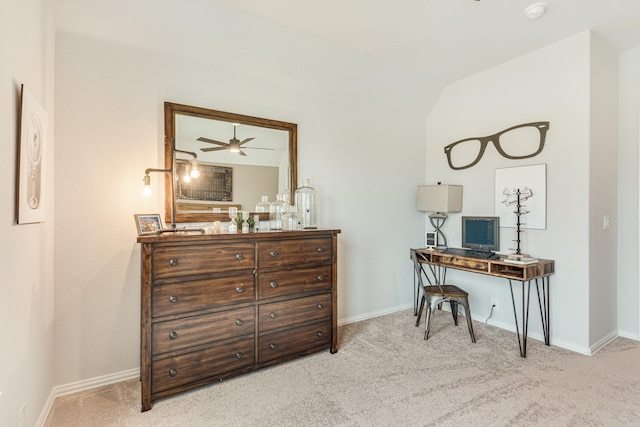 office space featuring light colored carpet, vaulted ceiling, and baseboards